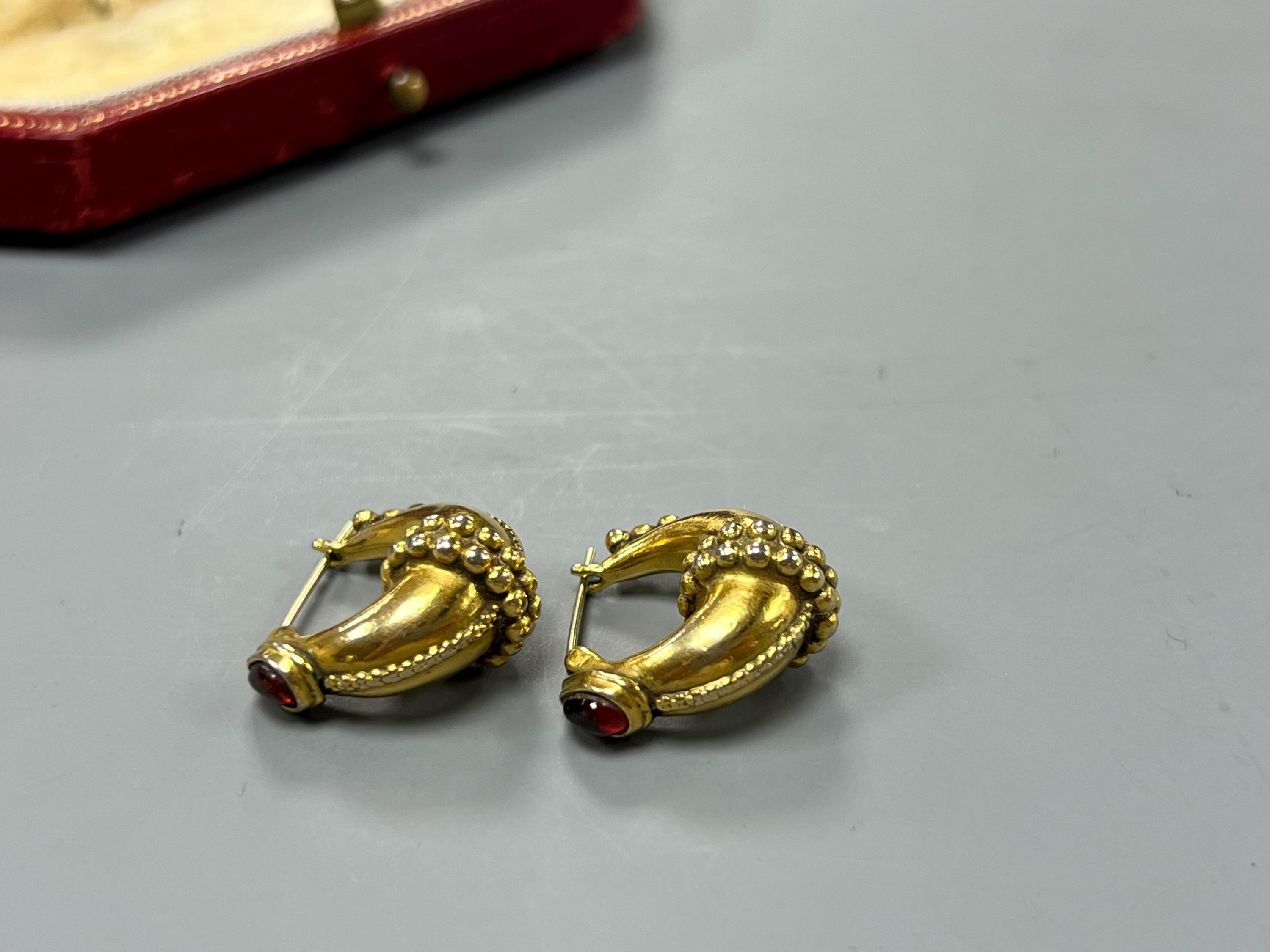 A modern pair of gilt metal earrings, together with a Cartier gilt tooled red leather jewellery box.